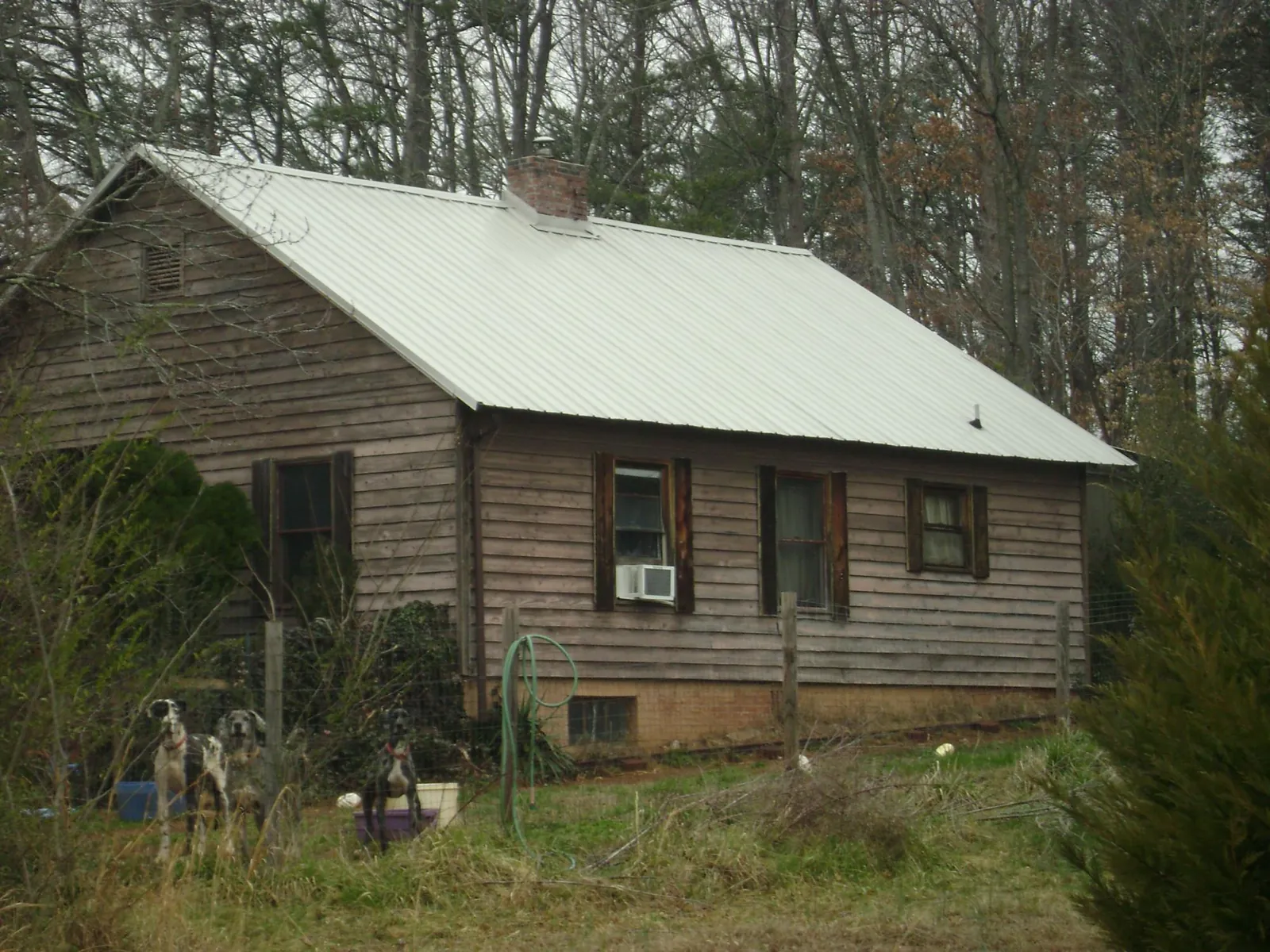 White metal roof on an old wood sided farmhouse, from a Metal Roof Installation job in Farmingdale